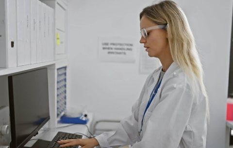 stock-photo-a-focused-blonde-woman-wearing-safety-glasses-works-on-a-computer-in-a-laboratory-setting-2458952993-transformed